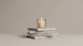 A Lit Candle in a Glass Holder Sits Atop Stacked White Rectangular Objects Royalty Free Stock Photo