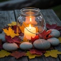 Lit candle in jar with fall leaves stones on rustic wood Royalty Free Stock Photo