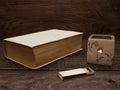 Candle, matches and book on a wooden table