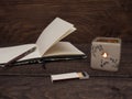 Candle, matches and notebook on a wooden table