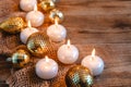 Lit candles, Christmas tree Golden baubles and burlap on a wooden background. New year`s and Christmas concept Royalty Free Stock Photo