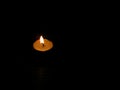 Burning candle in left position and dark background, copyspace. Royalty Free Stock Photo