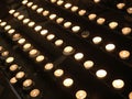 lit candles with the flame by pilgrims during the religious service inside the church Royalty Free Stock Photo