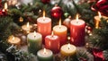 Lit Candles surrounded by Christmas decorations.