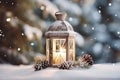 Lit Christmas lantern under the Christmas tree in the snow, covered with snow at night outdoors. Christmas mood. Selective focus.