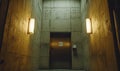 Modern Concrete Corridor with Ambient Lighting and Elevator Door Royalty Free Stock Photo