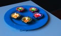 Diyas placed on plate to celebrate dhanteras