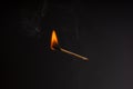 Lit falling match on a black background Royalty Free Stock Photo