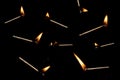 Lit and falling match on a black background Royalty Free Stock Photo