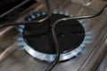 lit gas hob on high setting, blue gas flame visible Royalty Free Stock Photo