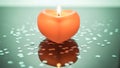Lit Heart-Shaped Candle on Reflective Surface Royalty Free Stock Photo