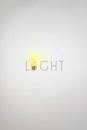 Lit light bulb with text on vignette white background