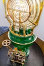 Lit Lighthouse light, with a view of the Fresnel optic system and the old clock mechanism at the bottom Royalty Free Stock Photo