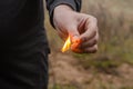 A lit match in a male hand outdoors Royalty Free Stock Photo