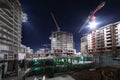 Lit multi-storey buildings under twenty-four-hour construction Royalty Free Stock Photo