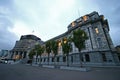 Modern expansion of conic Beehive in gray concrete to old Edwardian parliament illuminated at dusk, Wellington, New Zealand Royalty Free Stock Photo