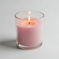 A lit pink scented candle in a clear glass jar Royalty Free Stock Photo