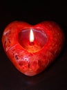 Lit red heart candle, dark background Royalty Free Stock Photo