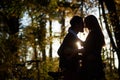 Romantic couple, man and attractive girl close together at tandem bicycle in dark autumn park. Royalty Free Stock Photo