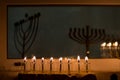 Lit and unlit Hanukkah menorahs in a window Royalty Free Stock Photo