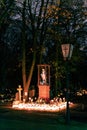 Lit up candles surrounding a statue of the Virgin Mary in a cemetery on All Saints Day in Poland Royalty Free Stock Photo