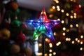 a lit up star topper on a christmas tree Royalty Free Stock Photo