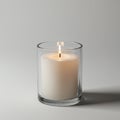 A lit white cylindrical candle is placed inside a transparent glass holder, emitting a gen Royalty Free Stock Photo