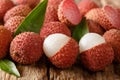 Litchi, lichee, lychee, or lichi, Litchi chinensis on old rustic wood background. horizontal