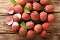 Litchi, lichee, lychee, or lichi, Litchi chinensis on old rustic wood background. Horizontal top view