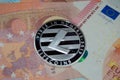 Litecoin close up on top of euro paper monete