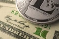 Litecoin crypto currency coin close-up view on background of US dollars