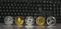 Different virtual coins with keyboard background