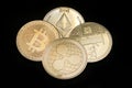 Litecoin, Ripple, Ethereum & Bitcoin gold coins representing cryptocurrencies against a black background