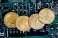 Litecoin, Ripple, Ethereum & Bitcoin gold coins representing cryptocurrenies against a computer circuit board