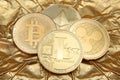 Litecoin, Ripple, Ethereum & Bitcoin golden coins representing cryptocurrencies against a gold background