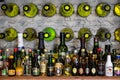 A collection of different alcoholic beverages bottles on the shelf in the cellar Royalty Free Stock Photo