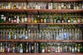 A collection of different alcoholic beverages bottles on the shelf in the cellar Royalty Free Stock Photo