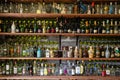 A collection of different alcoholic beverages bottles on the shelf in the cellar Royalty Free Stock Photo