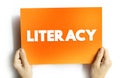 Literacy is the ability to read, write, speak and listen, text concept on card for presentations and reports Royalty Free Stock Photo