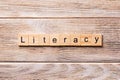 LITERACY word written on wood block. LITERACY text on wooden table for your desing, concept Royalty Free Stock Photo