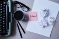 Literature, author and writer, writing and journalism concept: typewriter, coffee and glasses and paper with sticker Royalty Free Stock Photo