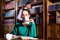 Literature cafe with cute girl and man. woman in library read book at teapot drinking coffee from cup. student life in Royalty Free Stock Photo