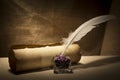 Literature concept. Old inkstand with feather near scroll on canvas background