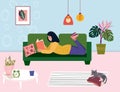 Literature fan is lying on couch and read book. Woman is reading textbook on the sofa, in hygge living room. Student Royalty Free Stock Photo