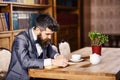 Literature, study, work, research, education concept. Reader sits in luxury interior and reads book. Bearded man in