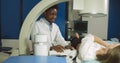 Lithotripsy for kidney and ureteral stones in modern center. Professional African man doctor, using ultrasound scan to