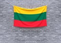 Lithuania flag hanging on brick wall