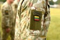 Lithuania patch flag on soldiers arm. Lithuanian military uniform. Lithuania troops Royalty Free Stock Photo