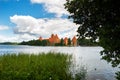 Lithuania. View on Trakai castle across lake and white yacht under sail Royalty Free Stock Photo