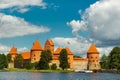 Lithuania. View on Trakai castle across lake and white yacht under sail Royalty Free Stock Photo